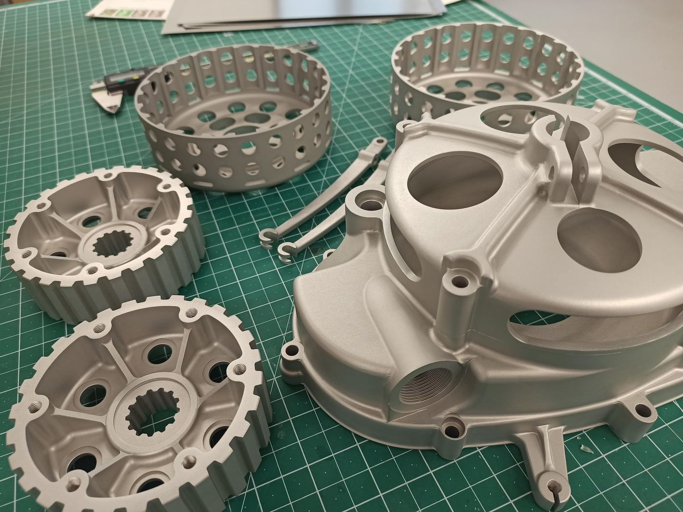 Machined engine casing components on a cutting mat